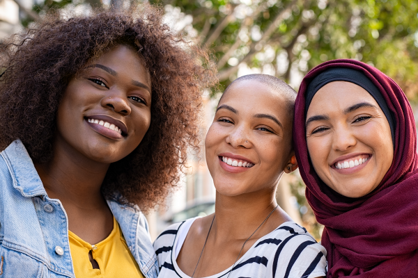 Three women smiling at the camera 